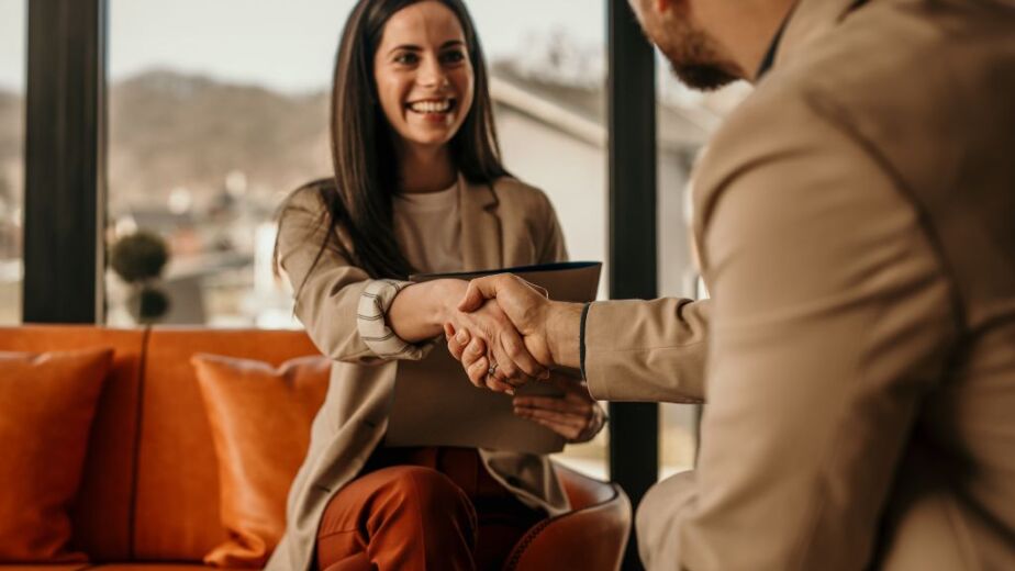 woman shaking mans hand during contract to hire transition