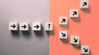 Wood blocks with arrows in a line splitting into two paths of contract vs full time employee