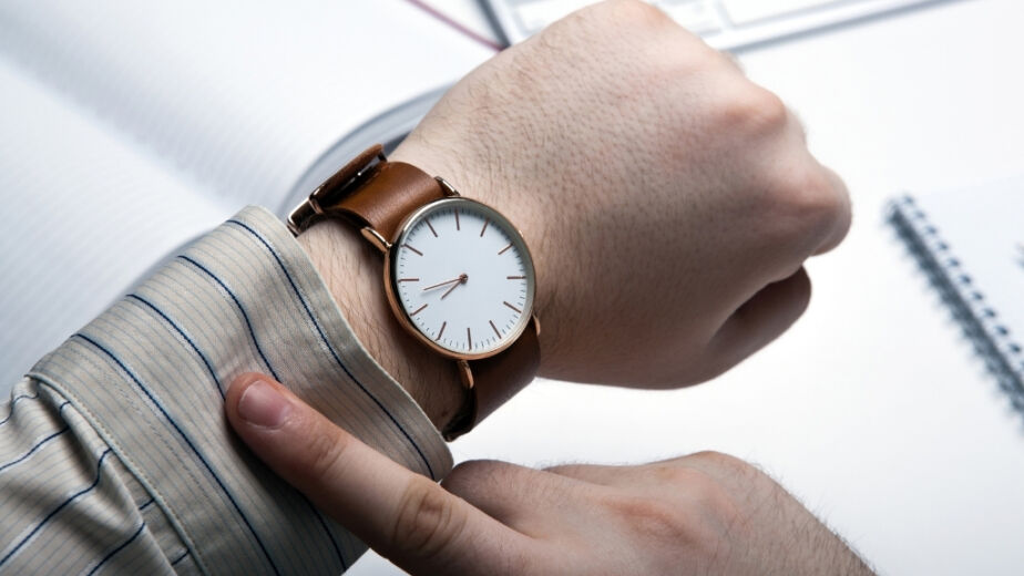 Man checking watch for time left in interim leadership