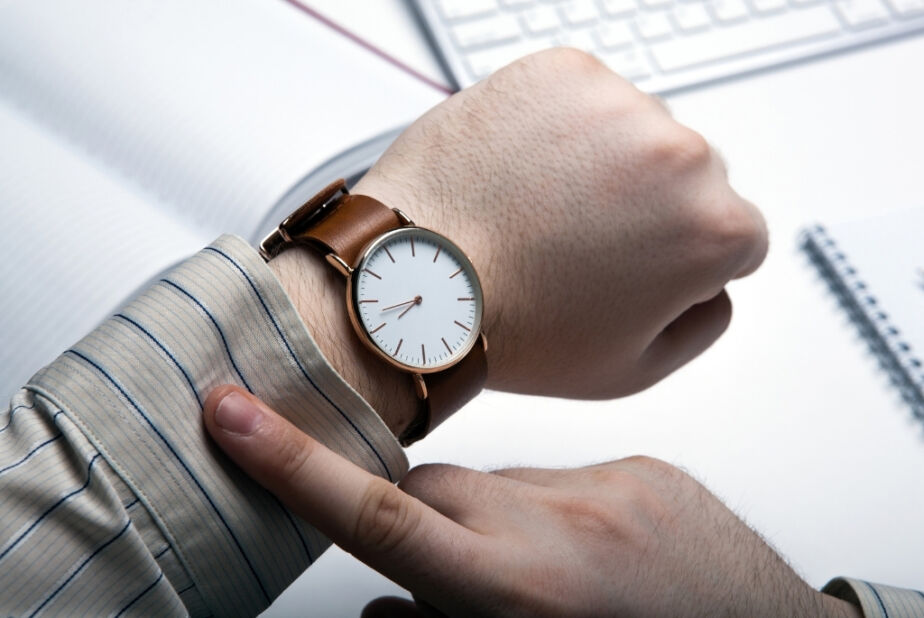 Man checking watch for time left in interim leadership