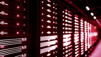 Line of servers glow with red light in data center project