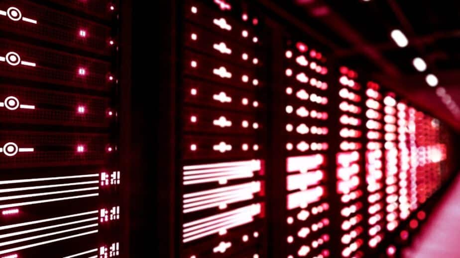 Line of servers glow with red light in data center project
