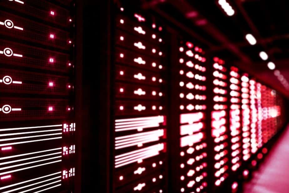 Line of servers glow with red light in data center project