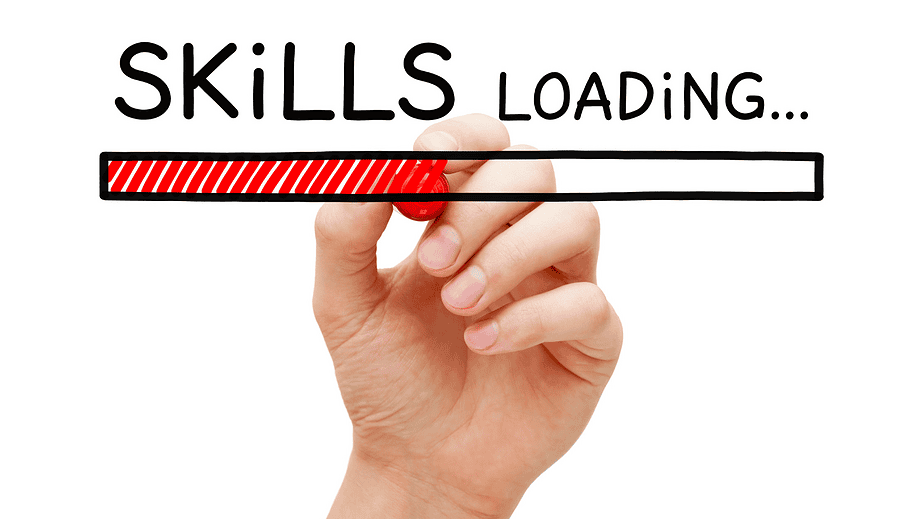 Hand holding marker writing "Skills Loading..." with red loading bar in whiteboard style art